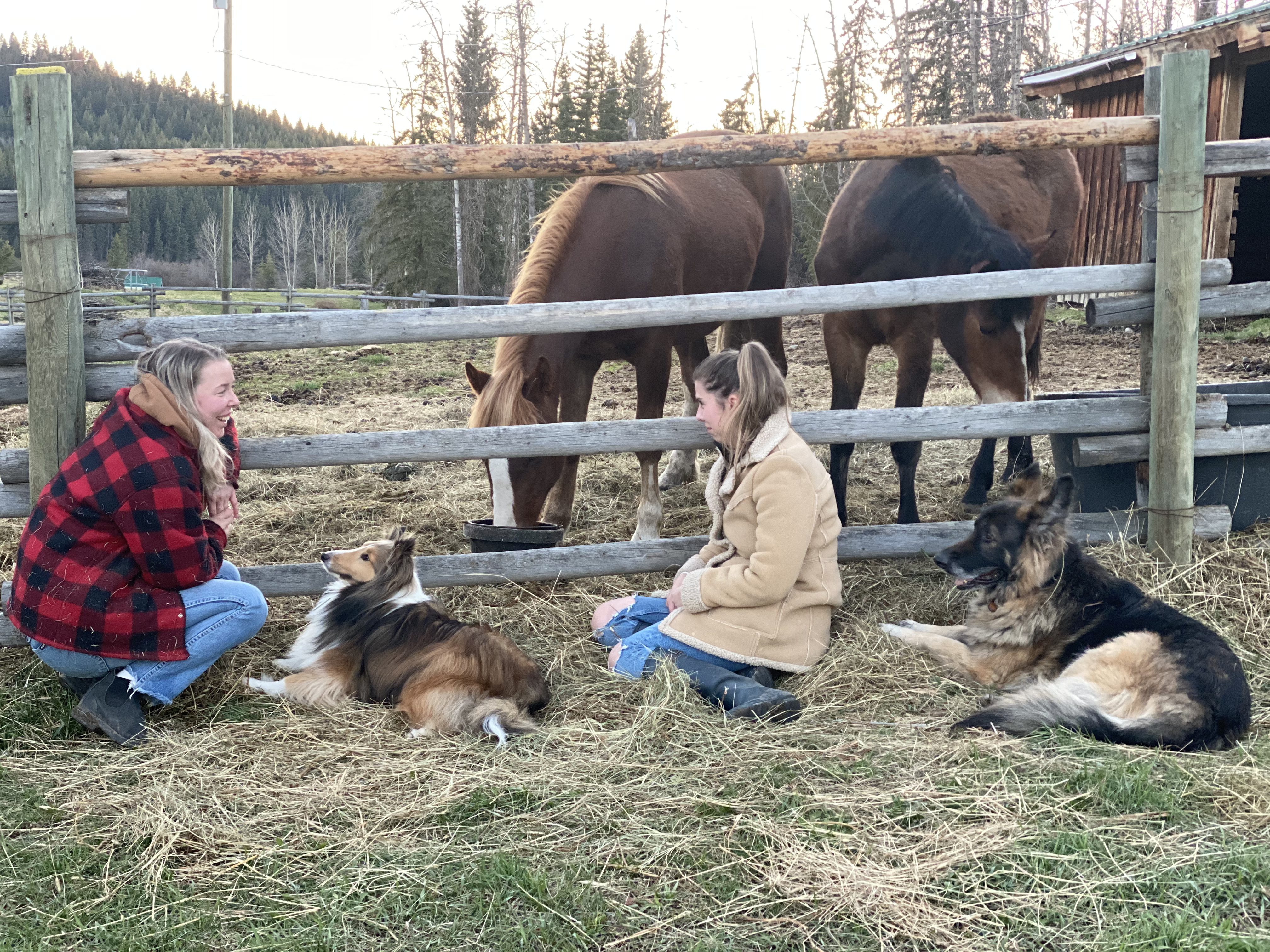 Founders Madison and Alexsandra with horses and farm dogs